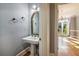 Powder room with pedestal sink and ornate mirror at 230 Wessex Ct, Atlanta, GA 30328
