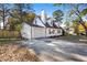 View of the house's side elevation, showcasing the garage and driveway at 1095 Woodington Cir, Lawrenceville, GA 30044