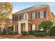 Brick home with black shutters, white columns, and landscaping at 3527 Preserve Se Dr, Atlanta, GA 30339