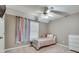 Charming bedroom with a twin-size bed and rainbow curtains at 144 Pleasant Grove Rd, Mcdonough, GA 30252