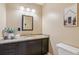 Updated bathroom with granite countertop and dark brown vanity at 1080 Tuxedo Dr, Roswell, GA 30075