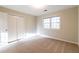 Spacious bedroom with neutral walls, carpet, and double doors at 1450 Gateside Ct, Snellville, GA 30078