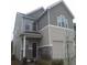 Two-story house with gray siding, stone accents, and a two-car garage at 2220 Arnold Mill Rd, Lawrenceville, GA 30044