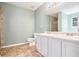 Main bathroom with double vanity, a shower, and light green walls at 547 Brenston Ct, Ellenwood, GA 30294