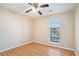 Bedroom with beige walls, wood-look floors, and ceiling fan at 547 Brenston Ct, Ellenwood, GA 30294