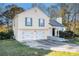 Two-story house with vinyl siding, two-car garage, and landscaping at 547 Brenston Ct, Ellenwood, GA 30294