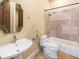 Bathroom with tile shower, bathtub, and pedestal sink at 1513 Jones Rd, Roswell, GA 30075
