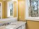 Bathroom with granite countertop, vanity, and large mirror at 1513 Jones Rd, Roswell, GA 30075
