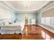 Bright bedroom with hardwood floors, large windows, and a white bed at 1513 Jones Rd, Roswell, GA 30075
