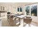 Bright breakfast room with a large table and access to the backyard at 1513 Jones Rd, Roswell, GA 30075
