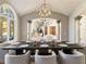 Elegant dining room with globe chandelier, arched windows, and hardwood floors at 1513 Jones Rd, Roswell, GA 30075