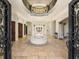 Grand two-story entry with tile floors, circular seating, and ornate columns at 1513 Jones Rd, Roswell, GA 30075
