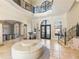 Two-story entry with circular seating and a view to the dining room at 1513 Jones Rd, Roswell, GA 30075