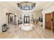 Spacious entry with double doors, two staircases, and a circular bench at 1513 Jones Rd, Roswell, GA 30075