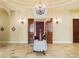 Elegant entry hall with tile floors, chandelier, and views to a home theater at 1513 Jones Rd, Roswell, GA 30075