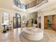 Two-story entryway with circular seating and a grand staircase at 1513 Jones Rd, Roswell, GA 30075
