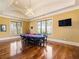 Game room with poker table and seating area, hardwood floors at 1513 Jones Rd, Roswell, GA 30075