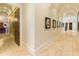 Long hallway with hardwood floors and framed artwork at 1513 Jones Rd, Roswell, GA 30075