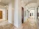 Grand hallway with travertine flooring and arched entryways at 1513 Jones Rd, Roswell, GA 30075