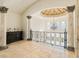 Open landing area with high ceilings, ornate railing, and stone flooring at 1513 Jones Rd, Roswell, GA 30075