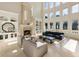 High-ceilinged living room with a fireplace and wall of windows at 1513 Jones Rd, Roswell, GA 30075