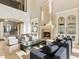 Spacious living room with a two story ceiling, fireplace and built-in shelving at 1513 Jones Rd, Roswell, GA 30075