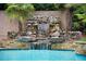 Inviting pool with a stunning stone waterfall feature at 1513 Jones Rd, Roswell, GA 30075