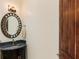 Small powder room with granite vanity and oval mirror at 1513 Jones Rd, Roswell, GA 30075