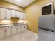 Wet bar with granite countertop, cabinets, and mini-fridge at 1513 Jones Rd, Roswell, GA 30075