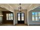 Bright and airy entryway with double doors and modern light fixture at 3390 Hillshire Dr, Cumming, GA 30028