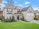 Two-story house with a large front yard, two-car garage, and landscaping at 6265 Stillwood Ln, Cumming, GA 30041