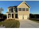 Two-story house with beige siding, three-car garage, and landscaped lawn at 510 Overlook Rd, Covington, GA 30014