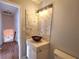 Modern bathroom with marble-look tile, copper sink, and updated vanity at 4284 Caroline Ct, Douglasville, GA 30135