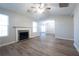 Living room with fireplace, hardwood floors, and vaulted ceiling at 150 Lake Ter, Mcdonough, GA 30253