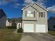 Two-story house with double garage and neat landscaping at 8258 Champion Trl, Fairburn, GA 30213