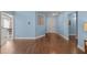 Living room with hardwood floors, light blue walls, and entryway access at 2253 Cheyenne Ln, Lawrenceville, GA 30044