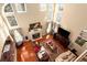 Two-story living room with hardwood floors, fireplace, and abundant natural light at 710 Trumpeter Ct, Fairburn, GA 30213