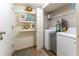 Bright laundry room with washer, dryer, and shelving at 111 Swanton Hill Ct, Decatur, GA 30030