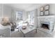 Bright living room features a fireplace, large windows, and comfortable seating at 111 Swanton Hill Ct, Decatur, GA 30030
