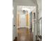 Bright entryway with hardwood floors, a mustard yellow wall, and white trim at 9150 Selborne Ln, Chattahoochee Hills, GA 30268