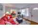 Bright living room with red couches and a view into dining area at 5592 Brady Dr, Stone Mountain, GA 30087