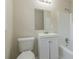 Clean bathroom with white vanity, toilet and bathtub at 6103 Oakwood Sw Cir, Covington, GA 30014
