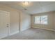 Bedroom with neutral walls, carpet flooring, and exterior door at 6103 Oakwood Sw Cir, Covington, GA 30014
