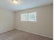 Bright bedroom with neutral walls, carpet flooring, and a window with blinds at 6103 Oakwood Sw Cir, Covington, GA 30014