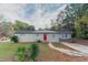 Charming ranch home with a red door and well-maintained lawn at 6103 Oakwood Sw Cir, Covington, GA 30014