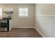 Kitchen corner with stainless steel appliances and wood flooring at 6103 Oakwood Sw Cir, Covington, GA 30014