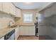 Full view of updated kitchen with granite countertops and white cabinets at 6103 Oakwood Sw Cir, Covington, GA 30014