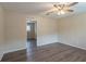 Open living area with hardwood floors and access to another room at 6103 Oakwood Sw Cir, Covington, GA 30014