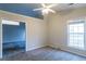 Spacious bedroom with carpet, ceiling fan, and large window at 822 Fairmont Park Dr, Dacula, GA 30019