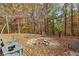 Fire pit area with seating, surrounded by woods at 7840 Highway 101, Rockmart, GA 30153